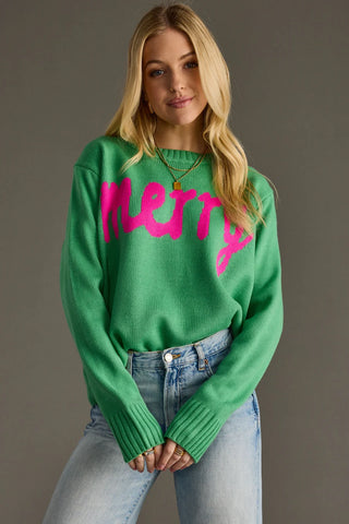 Woman wearing a green sweater with pink text against a gray background